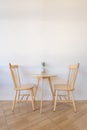 Modern set of wooden table and chairs interior in living room or coffee shop decoration with white wall concrete background Royalty Free Stock Photo