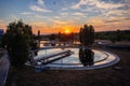 Modern sewage treatment plant. Wastewater purification tanks at sunset, aerial view