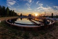 Modern sewage treatment plant. Wastewater purification tanks at sunset Royalty Free Stock Photo