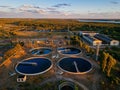 Modern sewage treatment plant. Round wastewater purification tanks at sunset, aerial view Royalty Free Stock Photo