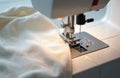 Modern sewing machine presser foot stitches light fabric with thread. Needle works on textile material creating a seam. Concept Royalty Free Stock Photo