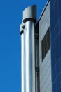 Modern shiny metal chimneys on a roof Royalty Free Stock Photo