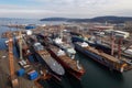 modern shipyard filled with a variety of ships in different stages of construction