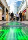Modern shopping mall corridor with interactive green led floor panels Royalty Free Stock Photo