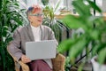 Happy successful business lady sitting with laptop
