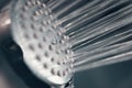 Modern shower head splashing water close up. Royalty Free Stock Photo