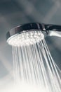 Modern shower head splashing water close up. Royalty Free Stock Photo