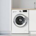 Modern White Front Load Washing Machine with Digital Display and Chrome Accents in a Laundry Room Setting Royalty Free Stock Photo