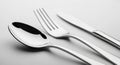 Polished Silver Spoon Fork and Knife Set on a Light Gray Background Royalty Free Stock Photo