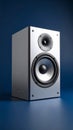 Modern silver bookshelf speaker with woofer and tweeter on a dark blue studio background Royalty Free Stock Photo