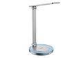 Modern silver desk lamp with wireless charging pad and adjustable arm on white background Royalty Free Stock Photo