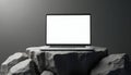 Modern silver laptop with blank white screen rests on rough grey rock podium. Clean digital device display, minimal background, Royalty Free Stock Photo