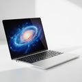Modern Silver Laptop Displaying a Vibrant Spiral Galaxy on its Screen computer technology Royalty Free Stock Photo