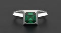 Modern Silver Ring with Square Emerald Cut Green Gemstone Centerpiece on Dark Gray Background Royalty Free Stock Photo
