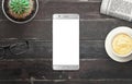 Modern silver smart phone with white isolated display for mockup in wooden table Royalty Free Stock Photo