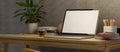 Modern simple home workspace with laptop blank screen mockup and decor on wooden desk Royalty Free Stock Photo