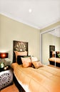 Modern single bedroom closeup focusing the wooden bed included a Royalty Free Stock Photo