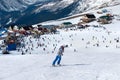 Modern ski resort in mountains. Dombai, Russia. Skier skiing downhill in high mountains