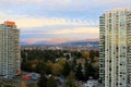 Modern skyline of the city of Surrey, Canada, featuring tall buildings under an overcast sky.