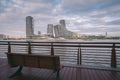 Modern skyline International Shipping Center in Haicang District, Xiamen city, with a bench in foreground beside the sea Royalty Free Stock Photo