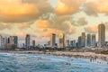 Modern skylines and luxury hotels under twilight at the beach near the old city Jaffa in Tel Aviv, and lots of tourists and locals