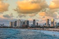 Modern skylines and luxury hotels under twilight at the beach near the old city Jaffa in Tel Aviv, and lots of tourists and locals