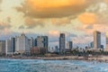 Modern skylines and luxury hotels under twilight at the beach near the old city Jaffa in Tel Aviv, and lots of tourists and locals