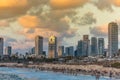 Modern skylines and luxury hotels under twilight at the beach near the old city Jaffa in Tel Aviv, and lots of tourists and locals