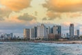 Modern skylines and luxury hotels under twilight at the beach near the old city Jaffa in Tel Aviv, and lots of tourists and locals