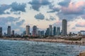 Modern skylines and luxury hotels under twilight at the beach near the old city Jaffa in Tel Aviv, and lots of tourists and locals