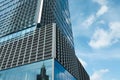 Modern skyscraper against blue sky with clouds, low angle view Royalty Free Stock Photo