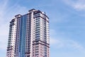 Modern skyscraper against blue sky with clouds. Space for text Royalty Free Stock Photo