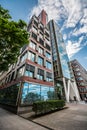 Tall modern building with clouds reflections in the windows. Hamburg, Germany. Royalty Free Stock Photo