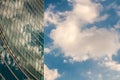 Modern skyscraper with reflections of clouds on windows Royalty Free Stock Photo