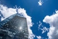 Modern skyscraper with reflections of clouds on windows Royalty Free Stock Photo