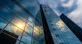 Modern skyscraper with reflective glass facade, capturing a partly cloudy sky and Royalty Free Stock Photo