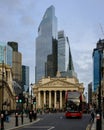 Modern skyscraper rises behind The Royal Exchange with red double decker bus