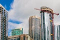 Modern skyscraper under construction with crane in a business district