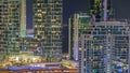 Modern skyscrapers in Dubai Marina, close up view to many illuminated windows aerial night timelapse. Royalty Free Stock Photo