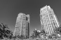 Modern skyscrapers high-rise buildings architecture and palms on blue sky in South Beach, USA