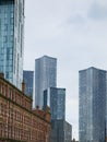 Modern skyscrapers= towers set against classical victorian buildings around Deansgate in Manchester, UK