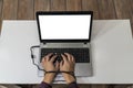 Modern problems concept. Man typing on laptop with hands tangled in the cable