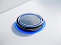 Modern sleek black button with blue led light glow on smooth white surface symbolizing futuristic technology and innovation Royalty Free Stock Photo