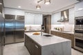 modern and sleek kitchen with stainless steel appliances and marble countertops