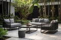 modern, sleek patio furniture with cushioned seats and vibrant accent pillows against a lush garden Royalty Free Stock Photo