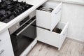 Modern sliding drawer system in the kitchen. Production of kitchen furniture. Ergonomics and design, close-up