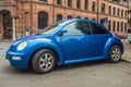 Modern small car Volkswagen New Beetle parked on a street Royalty Free Stock Photo