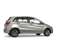 Modern small compact car in silver paint - side view