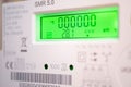 Modern smart electricity meter with green displa Royalty Free Stock Photo