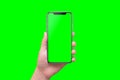 Modern smart phone in hand close-up. Isolated screen and background in green Royalty Free Stock Photo
